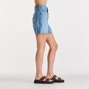 Person wearing denim shorts on a white background