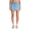 Person wearing a light blue denim skirt on a white background