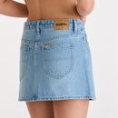 Blue denim skirt with a visible brand label on a plain background