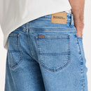 Blue jeans with a visible brand label on a white background