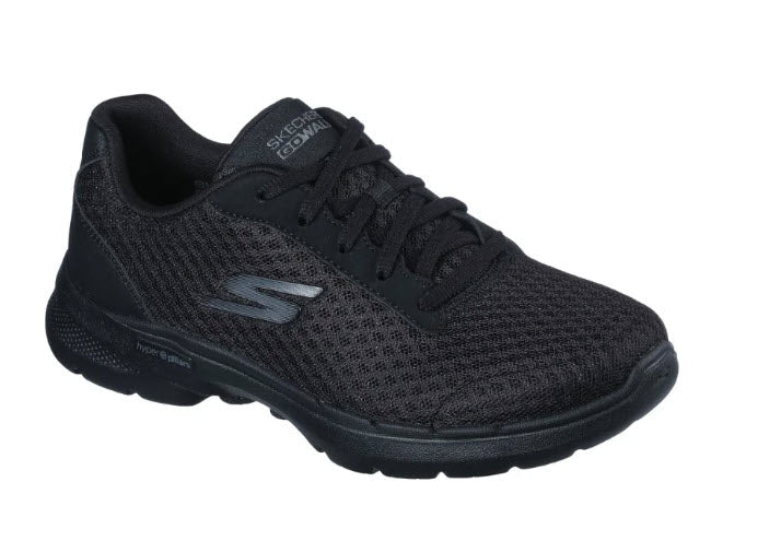 A pair of Skechers Go Walk 6 Iconic Vision black walking sneakers with a mesh upper and a Skechers logo on the side.