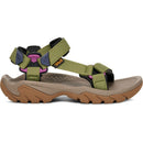 Teva sandal with green straps and brown sole on a white background