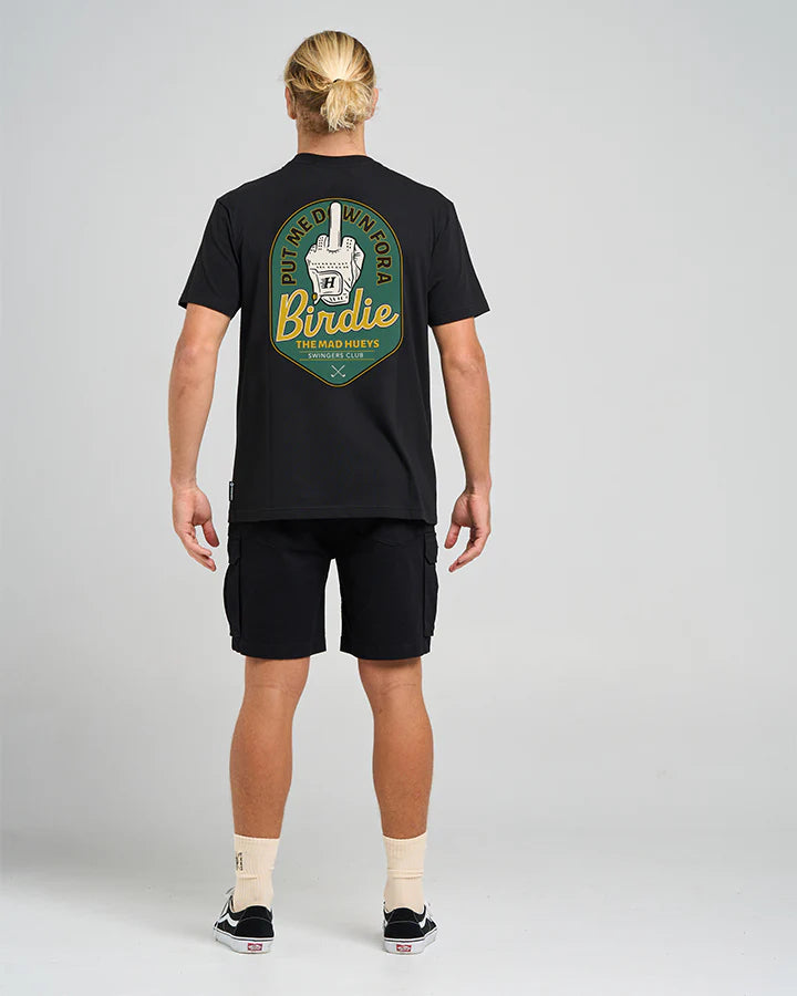 Person wearing a Mad Huey's black t-shirt with a logo on the back against a gray background