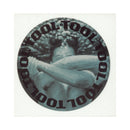 Round sticker with 'TOOL' text and a black and white image of a person holding a tool.