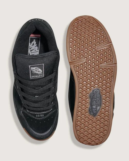 Black sneaker with brown sole on a white background