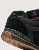 Black sneaker with 'Rowley' branding on a light gray background