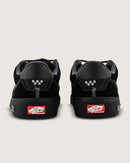 Black sneakers with a visible brand logo on a light gray background