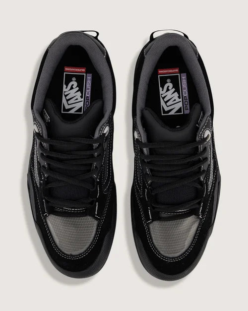 Black sneakers with a gray sole on a white background