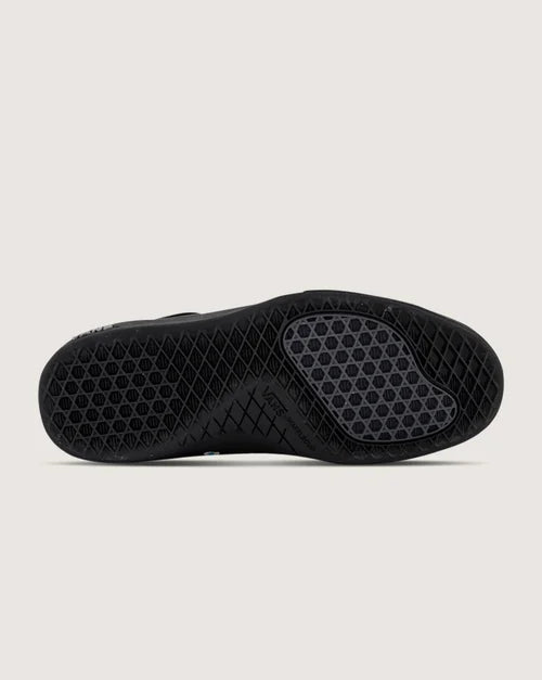 Black sole with textured sole on a light gray background