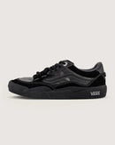 Black Vans sneaker on a light gray background