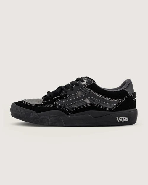 Black Vans sneaker on a light gray background