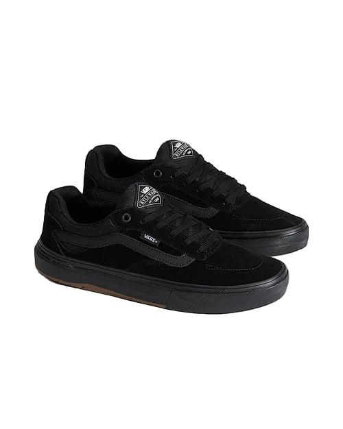 Black sneakers with a brand logo on a light gray background