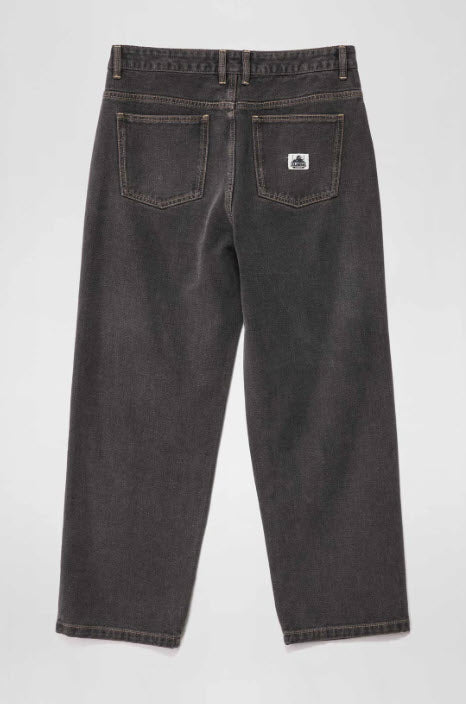 Dark gray jeans with a brand logo on the back pocket against a white background