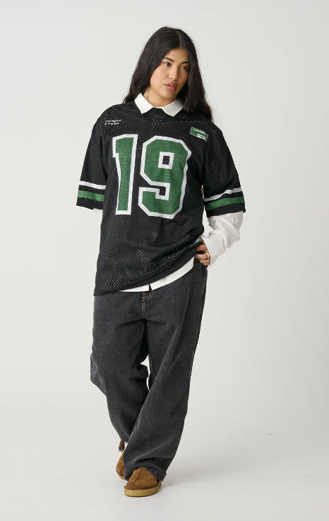 Person wearing a black sports jersey with the number 19 on a white background