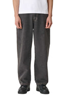 Person wearing dark gray jeans and a white shirt on a plain background