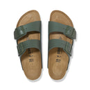 Pair of green sandals with cork sole on a white background