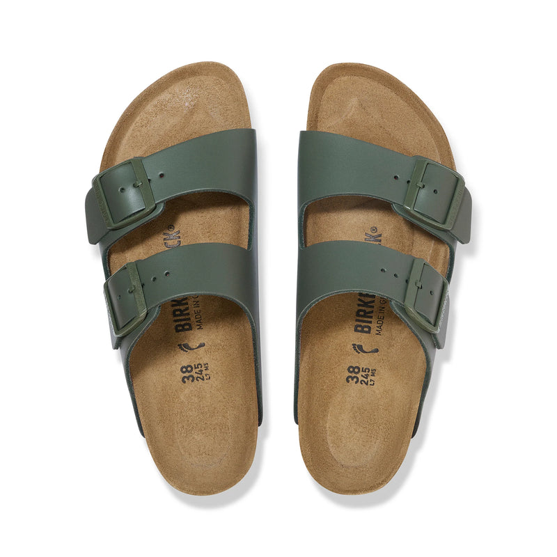 Pair of green sandals with cork sole on a white background