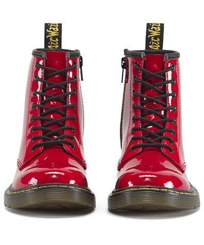 A red patent leather youth boot with a lace-up closure and a brand tag attached to it.
