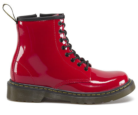 A red patent leather youth boot with a lace-up closure and a brand tag attached to it.