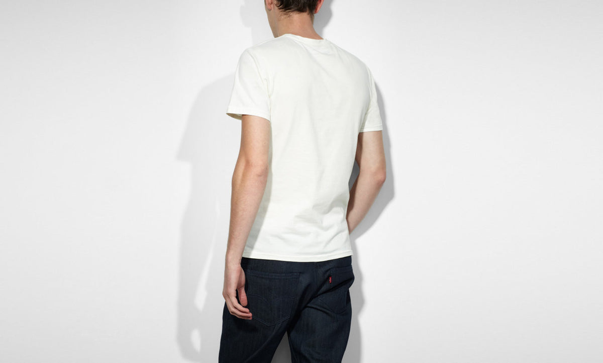 A male model wearing a white Levi's crew slim t-shirt with a marshmallow graphic on the front.