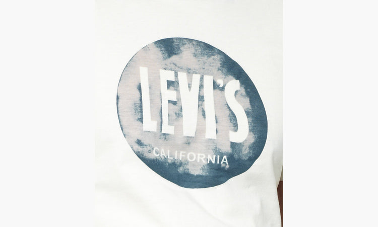 A male model wearing a white Levi's crew slim t-shirt with a marshmallow graphic on the front.