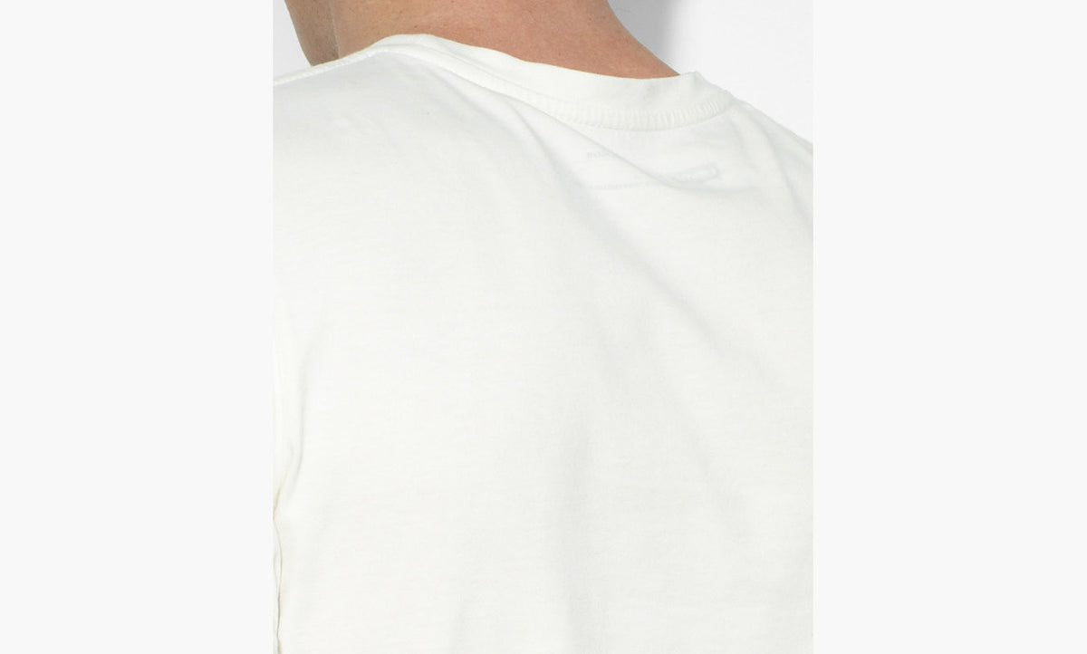 A male model wearing a white Levi's crew slim t-shirt with a marshmallow graphic on the front.