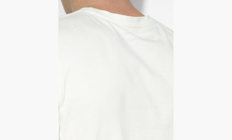 A male model wearing a white Levi's crew slim t-shirt with a marshmallow graphic on the front.