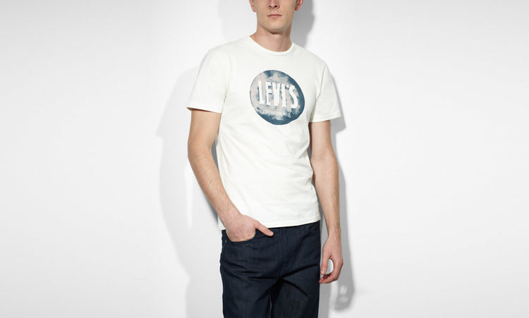 A male model wearing a white Levi's crew slim t-shirt with a marshmallow graphic on the front.