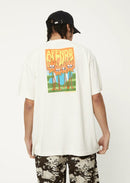 The image features the Afends Vibrations Hemp Boxy T-Shirt in an off-white color. The t-shirt has a relaxed, boxy fit with a ribbed neckline and a small front logo.