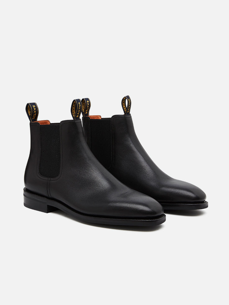 A pair of Baxter Drover black leather boots with elastic side panels and a closed heel.