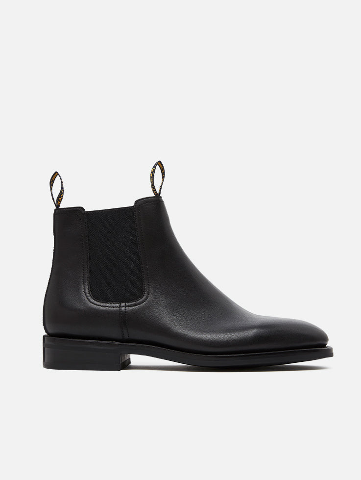 A pair of Baxter Drover black leather boots with elastic side panels and a closed heel.