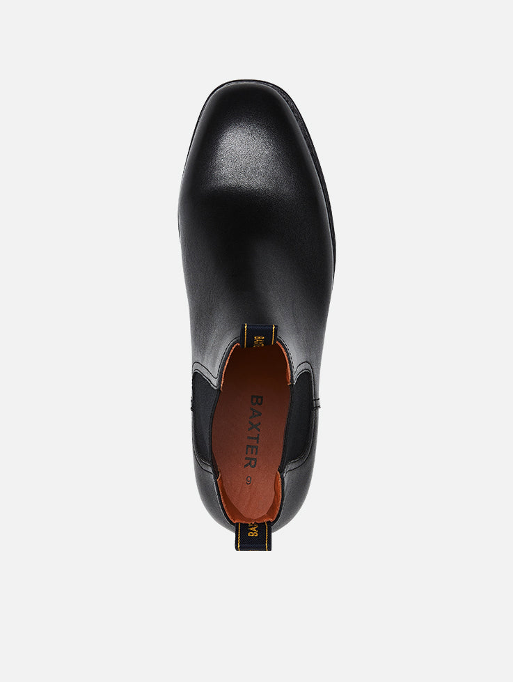 A pair of Baxter Drover black leather boots with elastic side panels and a closed heel.