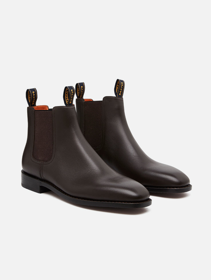 A pair of Baxter Drover walnut leather boots with elastic side panels on a white background.