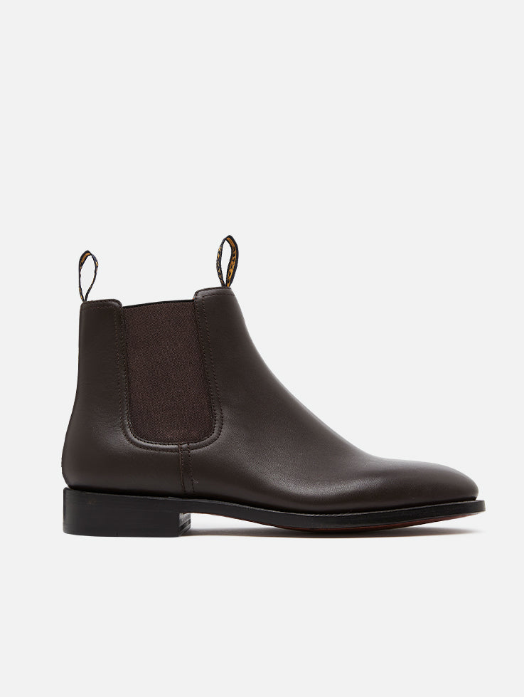 A pair of Baxter Drover walnut leather boots with elastic side panels on a white background.