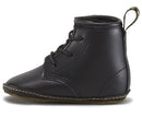 A black Dr Martens Auburn Crib Lace boot for newborns with a yellow stitch and a fabric heel loop.