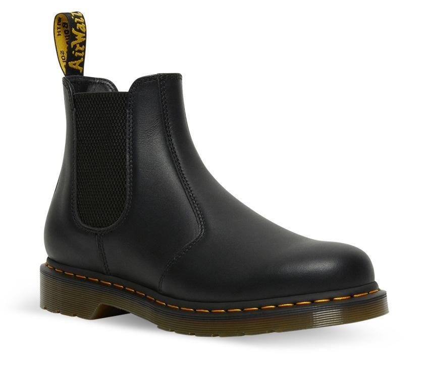A pair of Dr Martens 2976 Black Nappa Leather Chelsea Boots with yellow welt stitching and the brand's logo visible.
