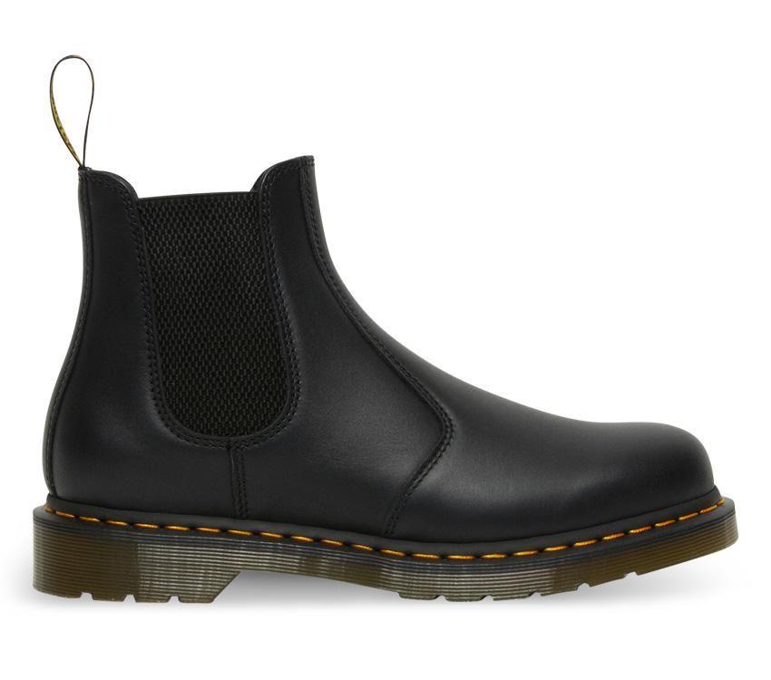 A pair of Dr Martens 2976 Black Nappa Leather Chelsea Boots with yellow welt stitching and the brand's logo visible.