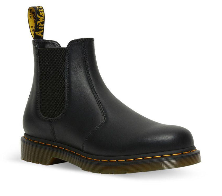 A pair of Dr Martens 2976 Black Nappa Leather Chelsea Boots with yellow welt stitching and the brand's logo visible.