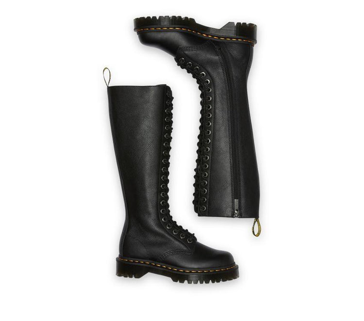 A pair of Dr Martens knee-high black boots with a lace-up front and an ankle zip, set against a white background.