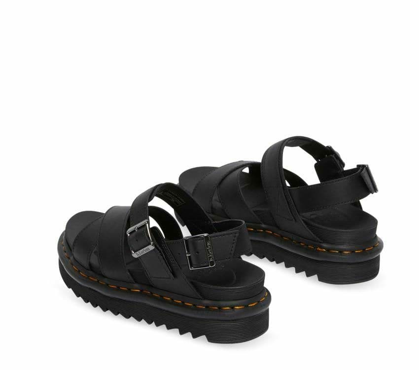 A pair of Dr Martens Voss II Black Hydro Leather Sandals with gunmetal buckles on a white background.