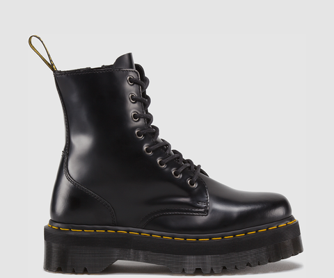 A black polished smooth boot with a thick sole and yellow stitching, featuring a lace-up closure and an inside zipper.
