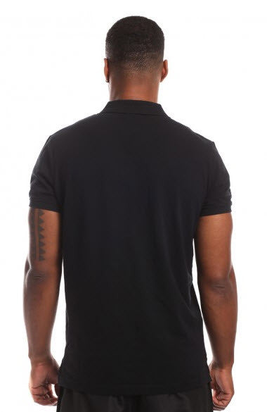A man wearing a black cotton pique Lonsdale Eric polo shirt with chest embroidery and a sleeve print.