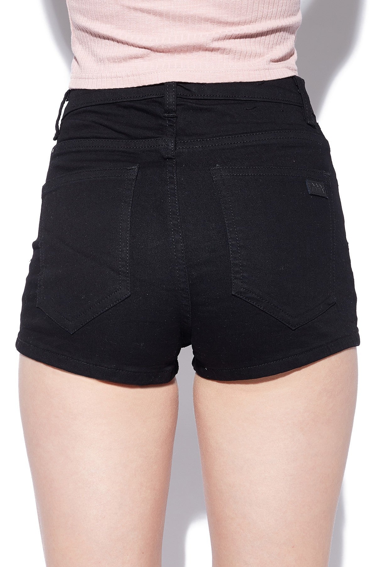 A pair of rigid blue denim kick shorts on a mannequin against a white background.