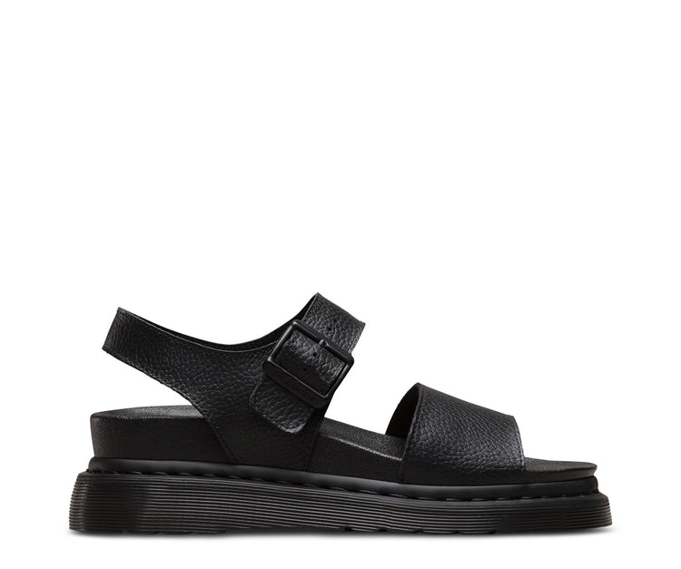 Black Dr Martens Romi Leather Sandal with pebbled texture, featuring a strap across the vamp and an ankle strap with a pin-buckle fastening on a rubber sole.